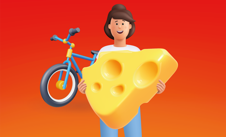 eine Zeichenfigur hält ein großes Stück Käse in der Hand, im Hintergrund ein Fahrrad.